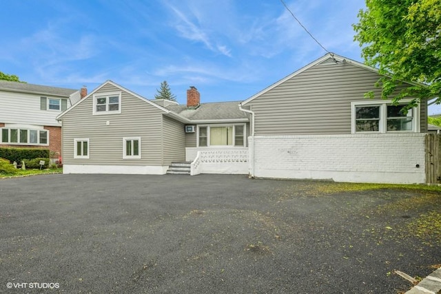 2600 Haff Ave, North Bellmore, NY 11710 - rear view of house with brick siding and a chimney