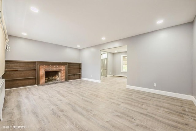 2600 Haff Ave, North Bellmore, NY 11710 - unfurnished living room with baseboards, light wood-style floors, recessed lighting, a baseboard heating unit, and a fireplace