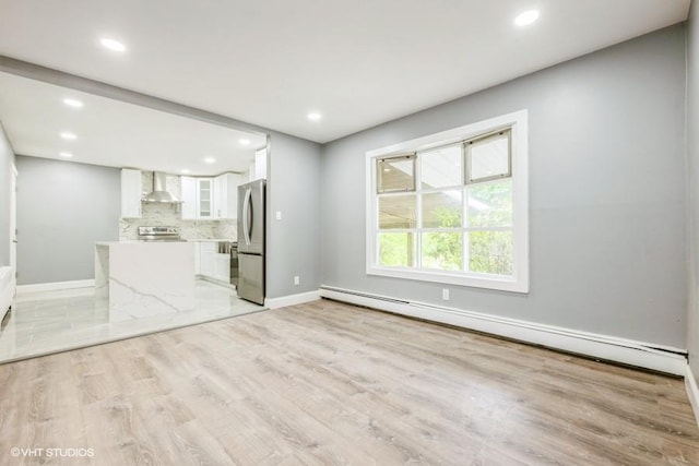 2600 Haff Ave, North Bellmore, NY 11710 - unfurnished living room featuring a baseboard heating unit, light wood-style flooring, baseboards, and recessed lighting