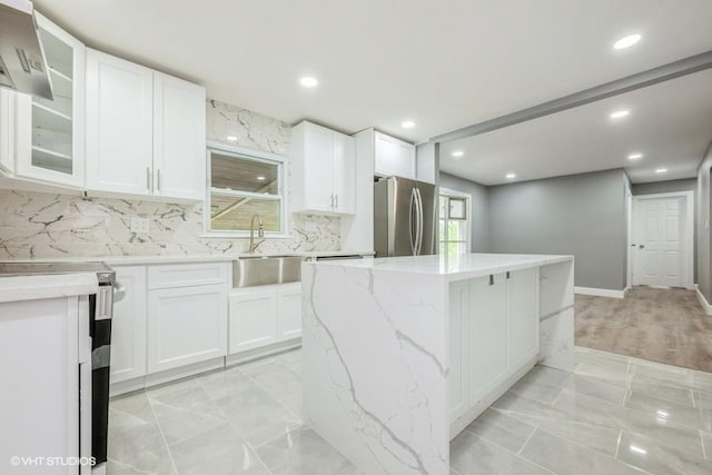 2600 Haff Ave, North Bellmore, NY 11710 - kitchen featuring freestanding refrigerator, electric range, a center island, a sink, and white cabinetry
