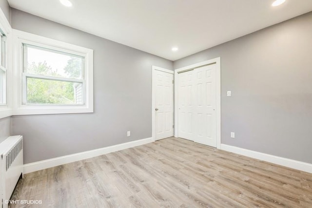 2600 Haff Ave, North Bellmore, NY 11710 - unfurnished bedroom featuring radiator, wood finished floors, baseboards, recessed lighting, and a closet