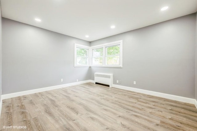 2600 Haff Ave, North Bellmore, NY 11710 - empty room featuring radiator, light wood-type flooring, baseboards, and recessed lighting