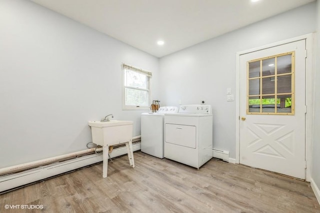 2600 Haff Ave, North Bellmore, NY 11710 - laundry room with washing machine and dryer, light wood-style flooring, a baseboard heating unit, recessed lighting, and baseboards