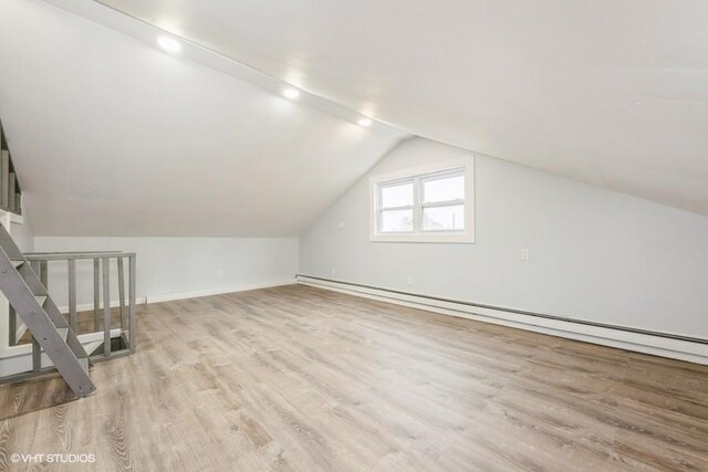 2600 Haff Ave, North Bellmore, NY 11710 - bonus room with a baseboard heating unit, light wood-style flooring, lofted ceiling, and baseboards
