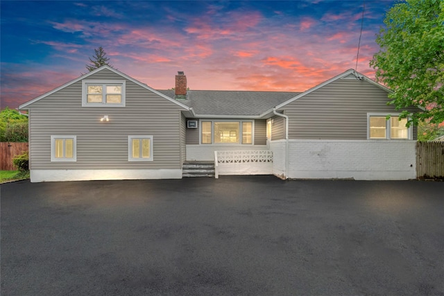 2600 Haff Ave, North Bellmore, NY 11710 - view of front of house with a chimney, brick siding, and roof with shingles