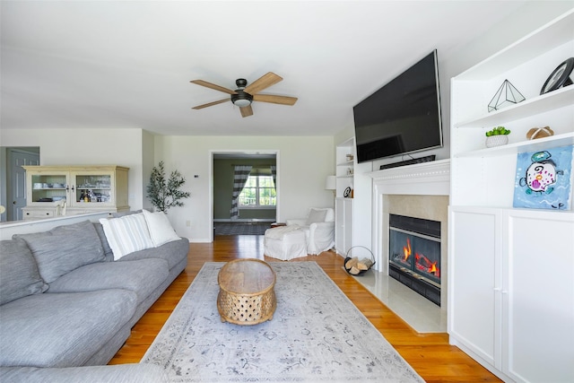 100 Meadow Ridge Ln, Lagrangeville, NY 12540 - living room featuring a ceiling fan, light wood-type flooring, and a fireplace with flush hearth
