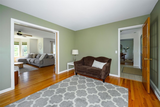 100 Meadow Ridge Ln, Lagrangeville, NY 12540 - living area with a baseboard radiator, wood finished floors, ceiling fan, and baseboard heating