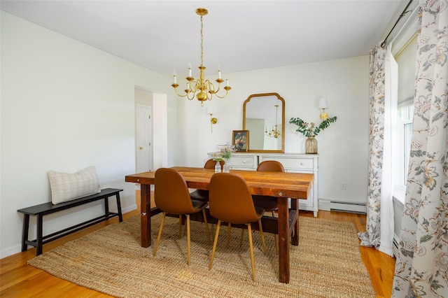 100 Meadow Ridge Ln, Lagrangeville, NY 12540 - dining room with a chandelier, wood finished floors, and a baseboard heating unit