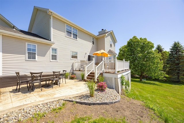 100 Meadow Ridge Ln, Lagrangeville, NY 12540 - rear view of property with a lawn, a patio, a wooden deck, and a chimney