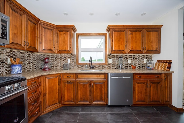 186 Oswego Rd, Pleasant Valley, NY 12569 - kitchen with stainless steel appliances, a sink, backsplash, and brown cabinets