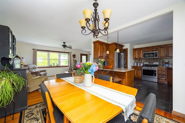 186 Oswego Rd, Pleasant Valley, NY 12569 - dining room featuring a ceiling fan, a chandelier, and dark tile patterned floors
