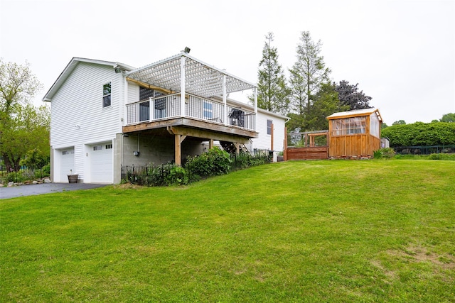 186 Oswego Rd, Pleasant Valley, NY 12569 - back of property featuring driveway, an attached garage, a wooden deck, and a lawn