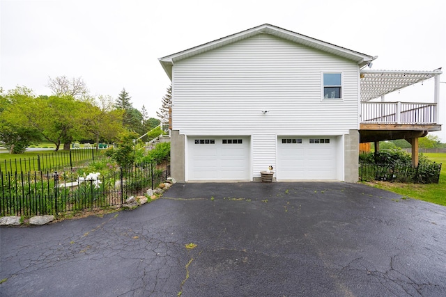 186 Oswego Rd, Pleasant Valley, NY 12569 - view of side of property with asphalt driveway, a garage, and a wooden deck