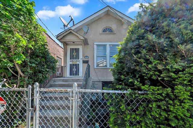 3038 Tiemann Ave, Bronx, NY 10469 - view of front facade featuring stucco siding and a gate