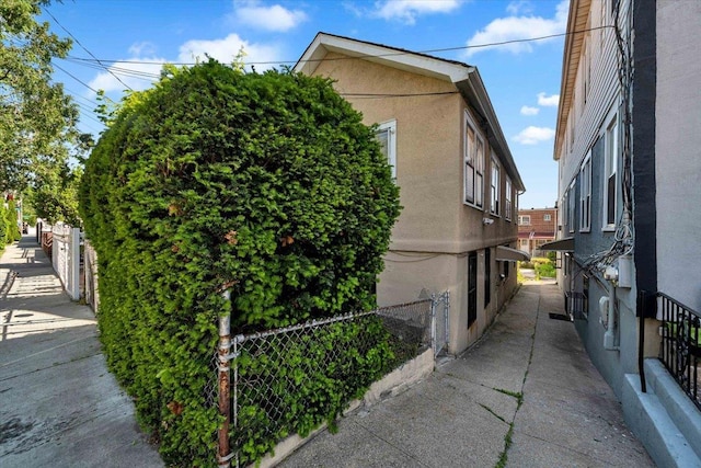 3038 Tiemann Ave, Bronx, NY 10469 - view of side of home with stucco siding