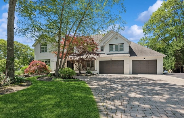 10 Colonial Dr, Smithtown, NY 11787 - view of front facade with decorative driveway, a front yard, and an attached garage