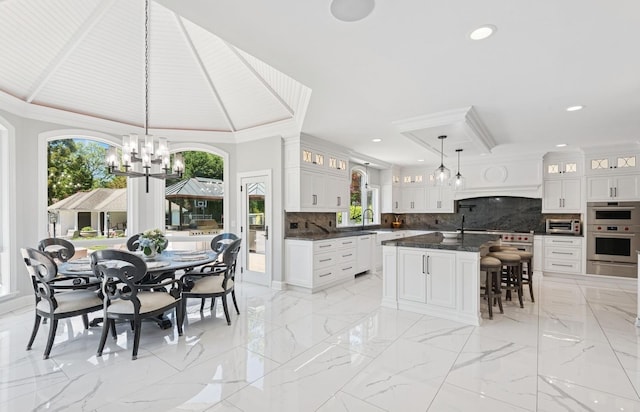10 Colonial Dr, Smithtown, NY 11787 - kitchen with a warming drawer, a chandelier, plenty of natural light, decorative backsplash, and recessed lighting