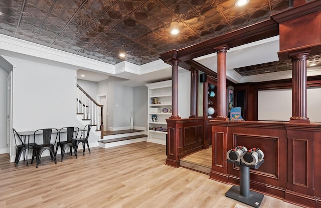 10 Colonial Dr, Smithtown, NY 11787 - bar area featuring crown molding, baseboards, decorative columns, an ornate ceiling, and light wood finished floors