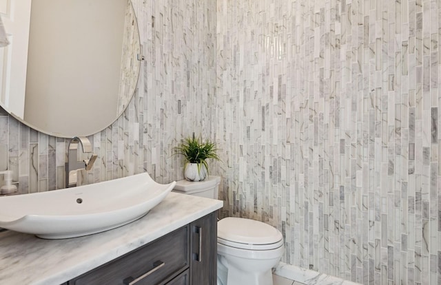 10 Colonial Dr, Smithtown, NY 11787 - bathroom with toilet, vanity, and tile walls