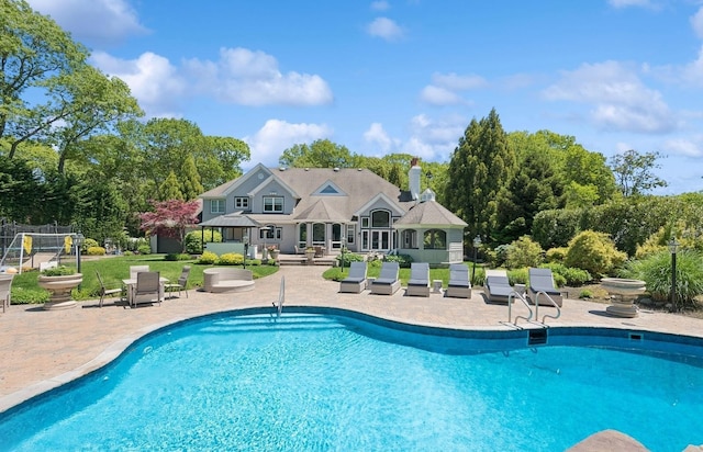 10 Colonial Dr, Smithtown, NY 11787 - swimming pool featuring a patio area and view of wooded area