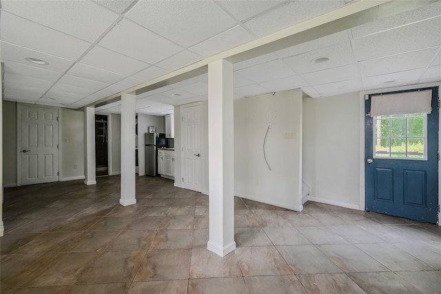 115 Dawn Rd, Rocky Point, NY 11778 - below grade area featuring a drop ceiling, freestanding refrigerator, and tile patterned flooring