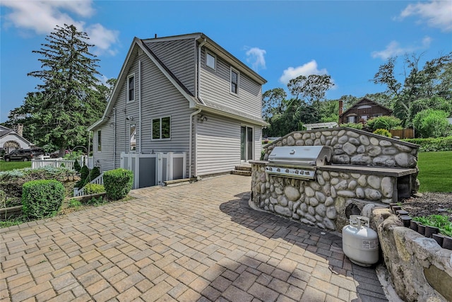 115 Dawn Rd, Rocky Point, NY 11778 - rear view of property featuring an outdoor kitchen and a patio