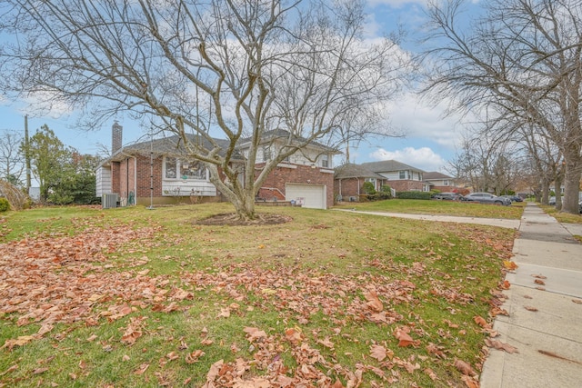 216 Birch Dr, New Hyde Park, NY 11040 - view of front of house with central AC, a chimney, brick siding, a front yard, and a garage