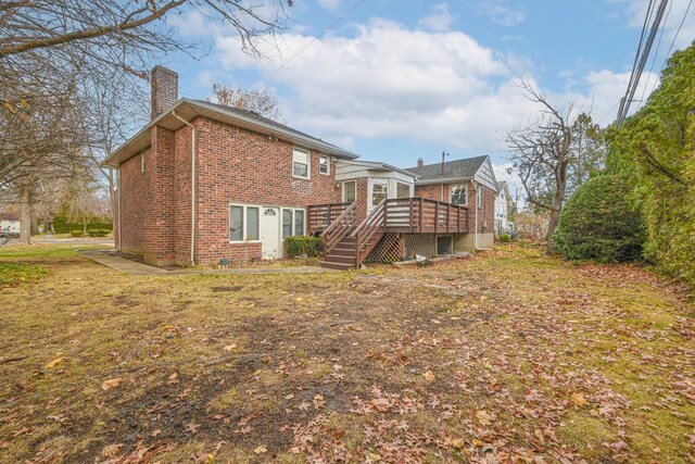 216 Birch Dr, New Hyde Park, NY 11040 - rear view of property with brick siding, a chimney, a wooden deck, and stairs