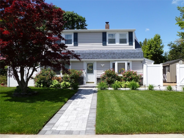 28 Crabtree Ln, Levittown, NY 11756 - view of front facade featuring a chimney and a front lawn