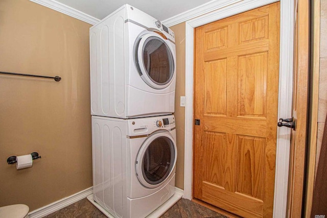 28 Crabtree Ln, Levittown, NY 11756 - laundry room featuring stacked washer / dryer, baseboards, and crown molding