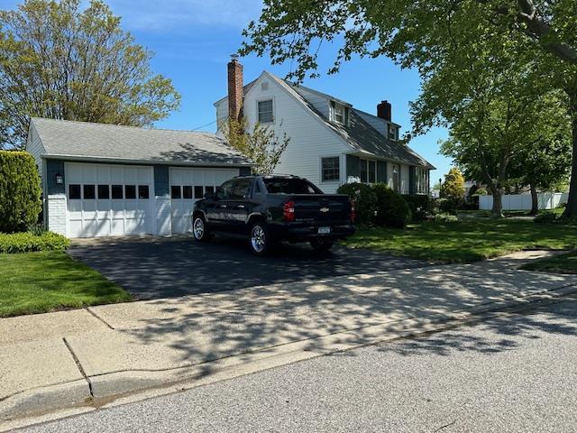 929 White Birch Ln, Wantagh, NY 11793 - view of front of property featuring a chimney and a front lawn