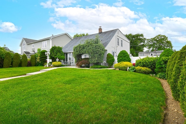 29 Castle Ln, Levittown, NY 11756 - view of front of property with a front lawn, a chimney, and a shingled roof