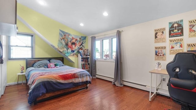 1434 Noel Ave, Hewlett, NY 11557 - bedroom featuring vaulted ceiling, multiple windows, a baseboard heating unit, wood finished floors, and recessed lighting