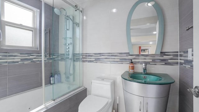 1434 Noel Ave, Hewlett, NY 11557 - full bathroom featuring enclosed tub / shower combo, tile walls, toilet, vanity, and backsplash