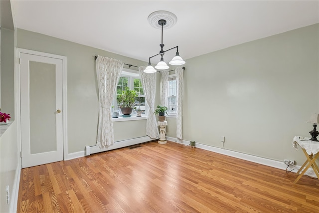 624 Westminster Rd, Baldwin, NY 11510 - unfurnished dining area with light wood finished floors, a baseboard radiator, baseboards, and a chandelier