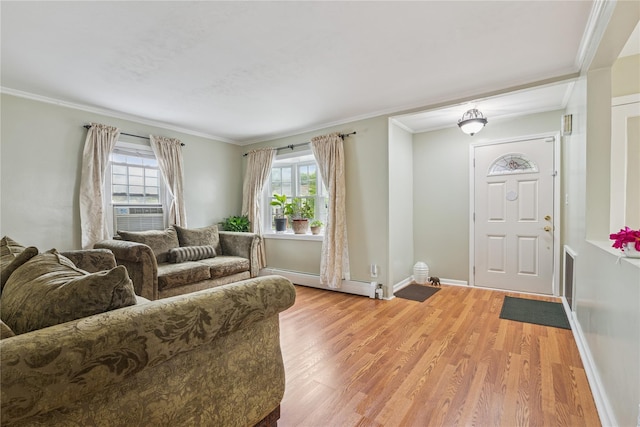 624 Westminster Rd, Baldwin, NY 11510 - living room featuring baseboard heating, plenty of natural light, light wood-style flooring, baseboards, and crown molding