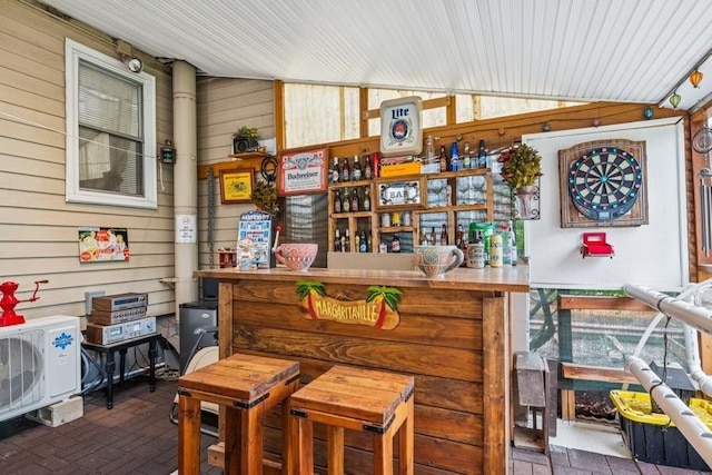 624 Westminster Rd, Baldwin, NY 11510 - bar area featuring wooden walls, ac unit, and brick patterned floors