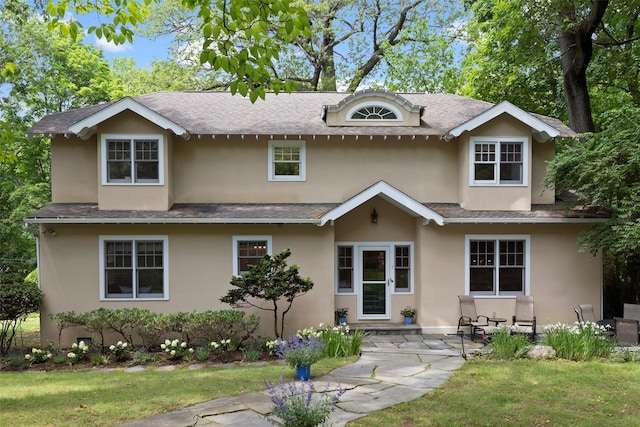 7 Ravine Dr, Hastings-On-Hudson, NY 10706 - traditional-style home with roof with shingles, stucco siding, and a front yard