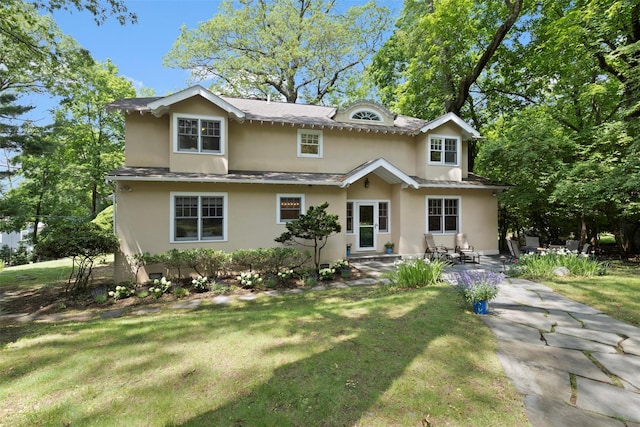 7 Ravine Dr, Hastings-On-Hudson, NY 10706 - traditional-style house with stucco siding and a front lawn