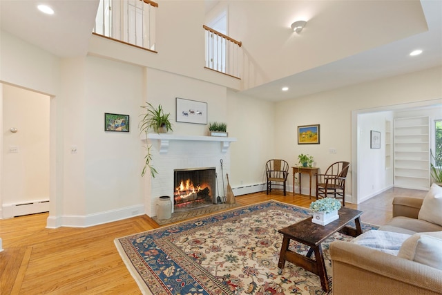 7 Ravine Dr, Hastings-On-Hudson, NY 10706 - living area featuring baseboard heating, a fireplace, baseboards, recessed lighting, and built in shelves