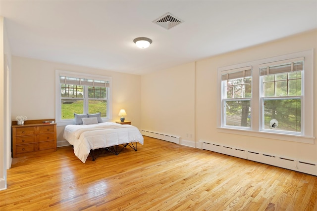 7 Ravine Dr, Hastings-On-Hudson, NY 10706 - bedroom with a baseboard radiator and light wood finished floors