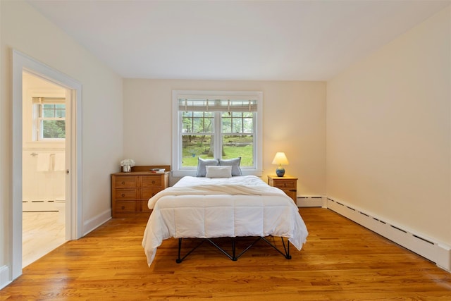 7 Ravine Dr, Hastings-On-Hudson, NY 10706 - bedroom with a baseboard radiator, light wood finished floors, baseboard heating, and connected bathroom