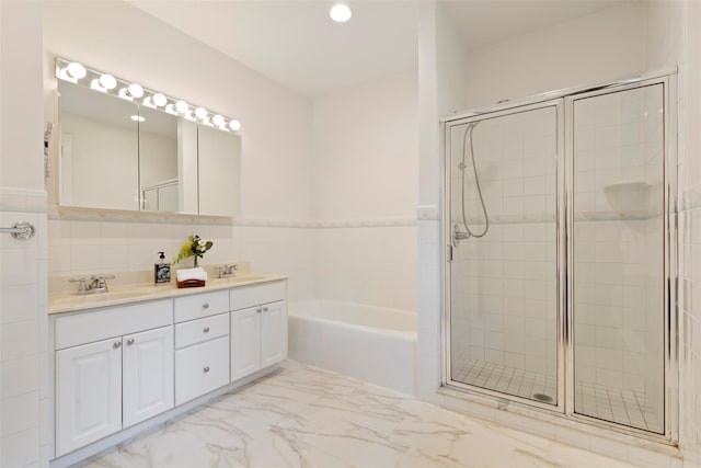 7 Ravine Dr, Hastings-On-Hudson, NY 10706 - bathroom featuring a garden tub, double vanity, a stall shower, marble look tile flooring, and recessed lighting