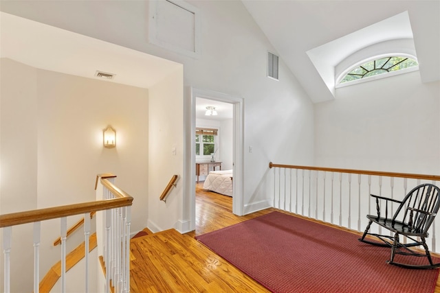 7 Ravine Dr, Hastings-On-Hudson, NY 10706 - hall with an upstairs landing, plenty of natural light, light wood-style floors, high vaulted ceiling, and baseboards