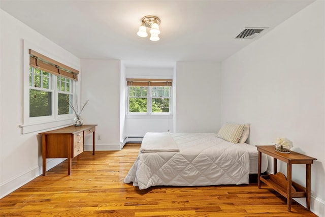 7 Ravine Dr, Hastings-On-Hudson, NY 10706 - bedroom with multiple windows, light wood-type flooring, a baseboard radiator, and baseboards