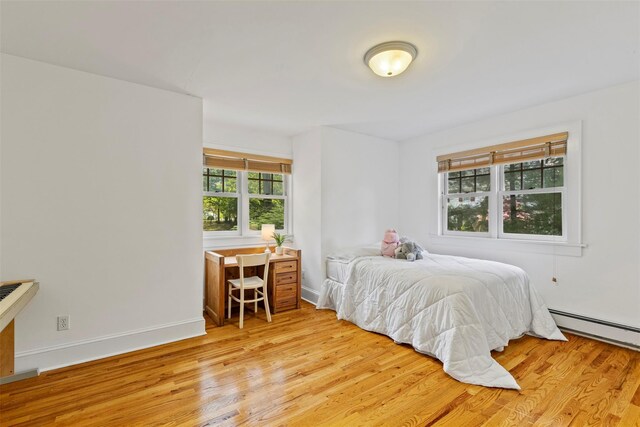 7 Ravine Dr, Hastings-On-Hudson, NY 10706 - bedroom with light wood-style flooring, baseboards, and a baseboard heating unit