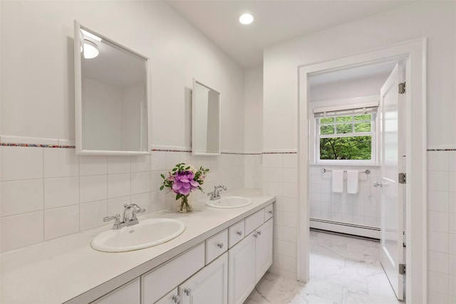 7 Ravine Dr, Hastings-On-Hudson, NY 10706 - full bath featuring a baseboard heating unit, tile walls, double vanity, marble finish flooring, and a wainscoted wall