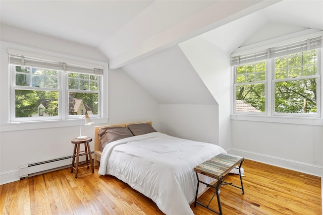 7 Ravine Dr, Hastings-On-Hudson, NY 10706 - bedroom featuring a baseboard heating unit, lofted ceiling, multiple windows, wood finished floors, and baseboards