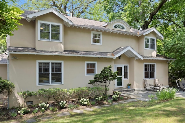 7 Ravine Dr, Hastings-On-Hudson, NY 10706 - back of house featuring stucco siding, a patio, and roof with shingles