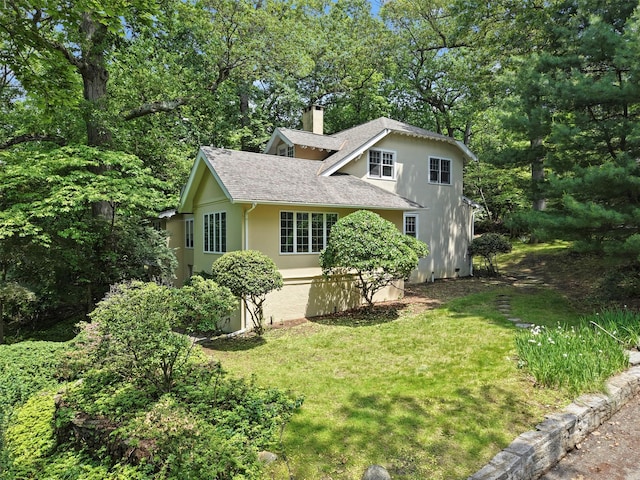 7 Ravine Dr, Hastings-On-Hudson, NY 10706 - view of front of home with a shingled roof, a chimney, stucco siding, and a front lawn